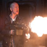 Bruce Willis fires a weapon in Die Hard